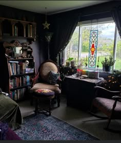 a living room filled with furniture next to a window covered in stained glass windows and bookshelves