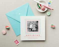 a holiday card with an image of two children on it next to candy and candies