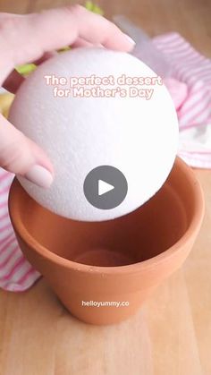 a person holding an egg in a bowl with the words, the perfect dessert for mother's day