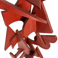 an abstract sculpture made out of red wood