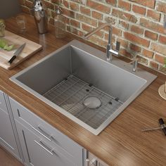 a kitchen sink sitting on top of a wooden counter