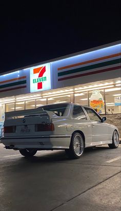 a silver car parked in front of a gas station