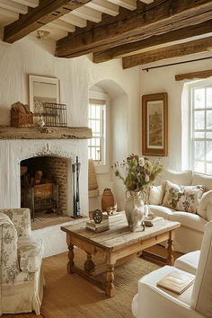 Cozy English cottage living room with a rustic fireplace, natural decor, and wooden beams. Wooden Beams Interior, Double Couches In Living Room, French Interior Living Room, Cozy Cottage Fireplace, French Cottage Fireplace, Cottage Core Fireplace, European Cottage Living Room, English Cottage Interiors Cozy, English Cottage Fireplace