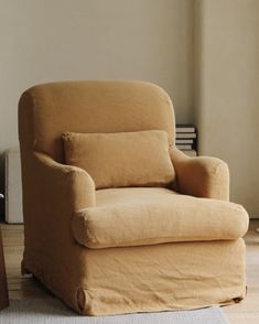 a chair that is sitting in the middle of a room with a rug on the floor