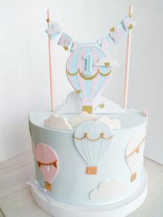 a birthday cake decorated with hot air balloons