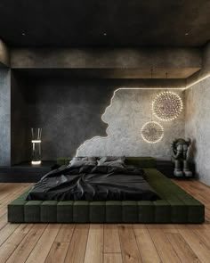 a bed sitting on top of a wooden floor next to a wall with lights above it