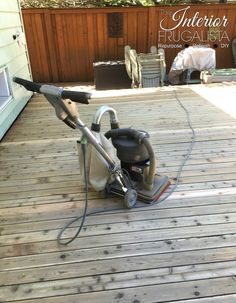 a pressure washer sitting on top of a wooden deck