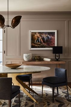 an elegant dining room with marble table and chairs