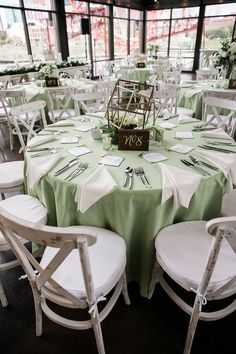 the tables are set with green and white linens