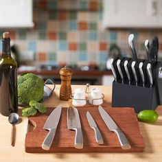 a cutting board with knives, broccoli and other kitchen utensils on it