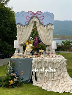 a table that has some food on it in front of a tent with curtains over it