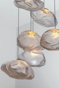 four glass lights hanging from the ceiling