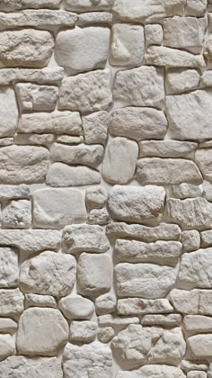 a white stone wall with some rocks on it