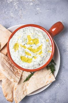 a plate with tortilla chips and dip