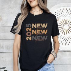 2025 New Year New Grace New Praise T-Shirt, Happy New Years T-Shirt, New Year 2025 TShirt, Funny New Years Tee, Kids 2025 Tee, New Year Tee  🌟Welcome to our collection of stylish and comfortable t-shirts specially designed for fashion enthusiasts!🌟 PRODUCT DETAILS: We take pride in using premium shirts from Bella Canvas and Gildan Soft Style for our prints. *Bella Canvas* - Unisex sizing - Lightweight at 4.2 oz. - Available in various compositions including 100% Combed Cotton, Ring-Spun Cotton, and Polyester blends. *Gildan Soft Style* - Unisex sizing - Available in different fabric compositions, including Ring Cotton, Polyester blends, and 100% Ring Cotton. If you would like either of these brands, please let us know. Otherwise, we will send you the one we have in stock. HOW TO ORDER: ? 2025 Shirt Design, 2025 Tshirt Design, New Year Bible Verse, New Year Shirts, Happy New Year Shirt, New Year Shirt, Funny New Year, New Years Shirts, Happy New Years