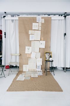 several pieces of paper are stacked on top of each other in front of a backdrop