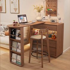 a laptop computer sitting on top of a wooden desk next to a chair and book shelf