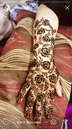 a woman's hand with henna tattoos on it