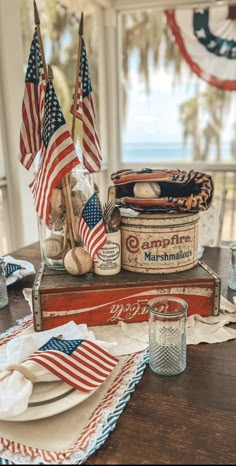 an old box with american flags and other patriotic items on it sitting on top of a wooden table