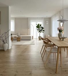 a dining room with wooden floors and white walls