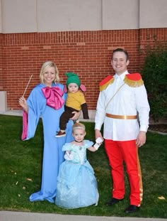 a man and woman in costumes standing next to a baby