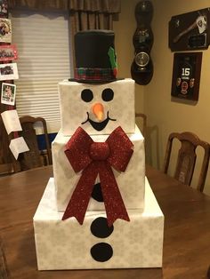 a snowman made out of cardboard sitting on top of a table