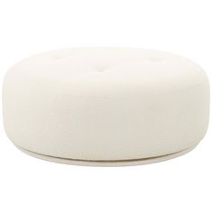 a white round ottoman sitting on top of a table