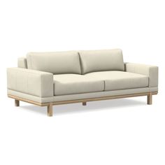 a white couch sitting on top of a wooden frame