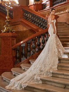 a woman in a wedding dress standing on some stairs