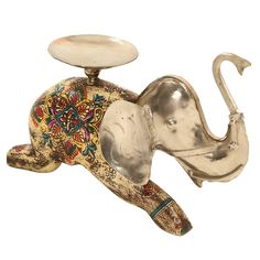 an elephant figurine is sitting on its side