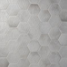 a white tiled wall with hexagonal tiles