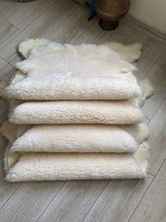 four sheepskin rugs laid out on the floor