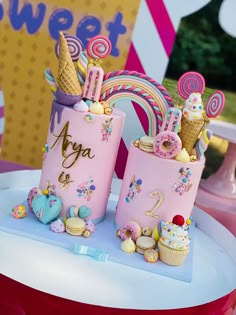 there are two cakes with ice cream cones on them and candy in the bottom one