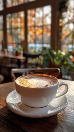 a cappuccino is sitting on a wooden table