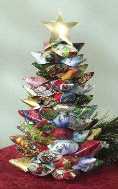 a christmas tree made out of glass plates and other decorative items on a red surface