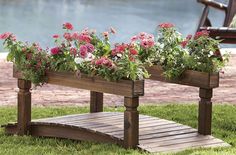 a wooden bench sitting on top of a lush green field