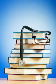 a stack of books with a stethoscope on top