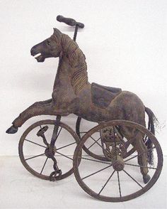 an old fashioned tricycle with a horse on it's front wheel and spokes