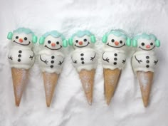 five snowmen are sitting in cones on the snow