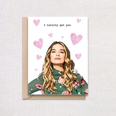 a card with a drawing of a woman's face and hearts in the background