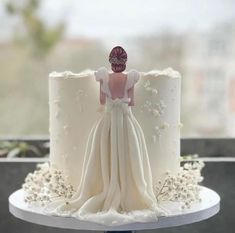 there is a wedding cake with a bride figurine on the top of it