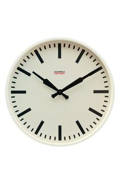 a white clock with black hands and numbers on the face is shown against a white background