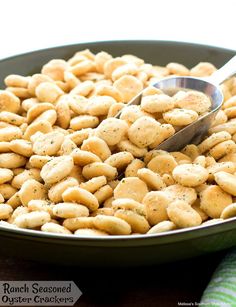 a bowl full of crackers with a spoon in it