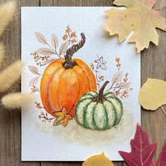 a watercolor painting of two pumpkins and leaves on a table with fall colors