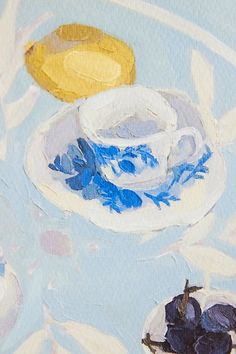 an oil painting of blue and white dishes on a table cloth with fruit in the background