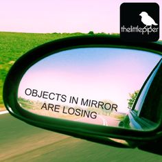 the side view mirror of a car reflecting an object in it's rear view mirror