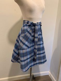 1970's Vintage Wrap Around Skirt ~ Navy Blue Vintage Plaid Print Skirt, Very Good Condition The two last photo shows its small issues. I will be mailing it Priority Mail and First Class International. Measurements Adjustable Waist ~ 26 Inch Length ~ 22 Inch Retro Cotton Pleated Skort, Retro Pleated Cotton Skort, Retro School Skort With Lined Skirt, Retro Blue Fitted Skort, Blue Retro Cotton Skort, Retro Blue Cotton Skort, Retro Pleated Skort For School, Vintage Mini Skirt For School, Retro High Waist Skirt For School