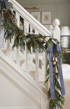 christmas garland with bells and pine cones on the banister