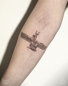 a tattoo on the arm of a person with an airplane in the sky behind it