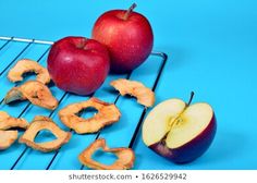 an apple and two pieces of fruit on a cooling rack with the word go spelled out